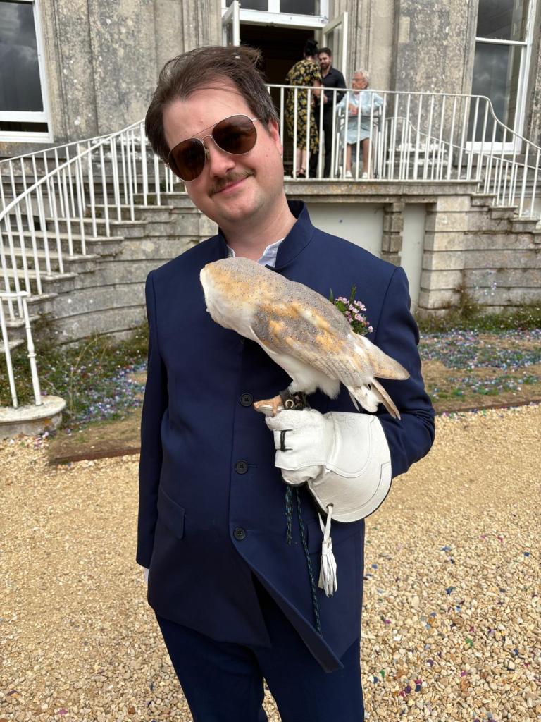 Comedian Andy Barr poses with a lovely barn owl at a wedding